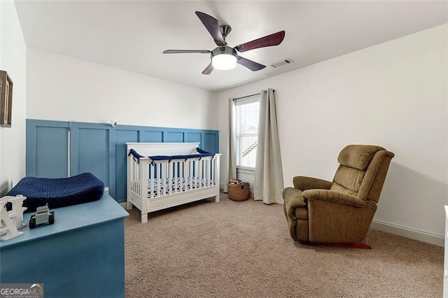 1399 Kilchis Falls Way, Braselton, GA 30517 - bedroom with carpet, a wainscoted wall, a crib, a ceiling fan, and a decorative wall