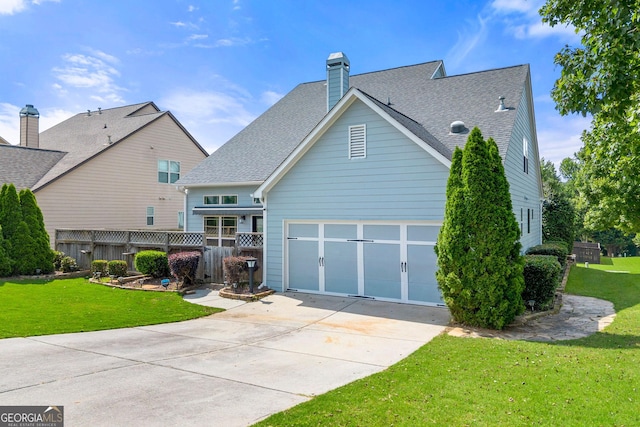 1399 Kilchis Falls Way, Braselton, GA 30517 - back of house featuring driveway, roof with shingles, a chimney, and a garage