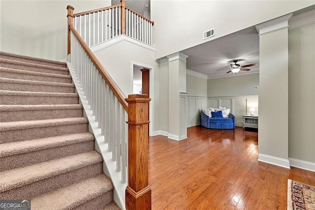 1399 Kilchis Falls Way, Braselton, GA 30517 - staircase featuring ceiling fan, wood finished floors, ornate columns, crown molding, and baseboards