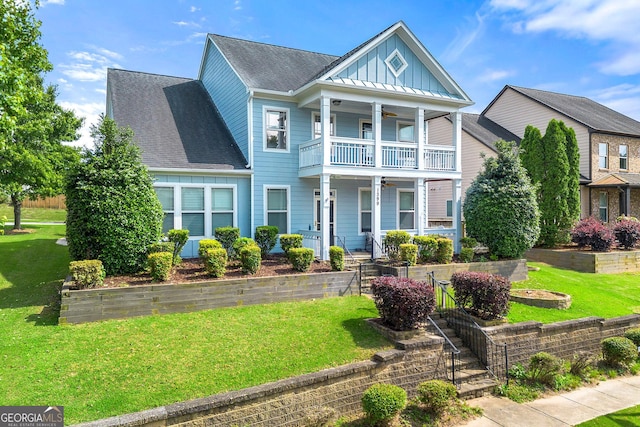 1399 Kilchis Falls Way, Braselton, GA 30517 - view of front of property featuring ceiling fan, a balcony, covered porch, board and batten siding, and a front yard