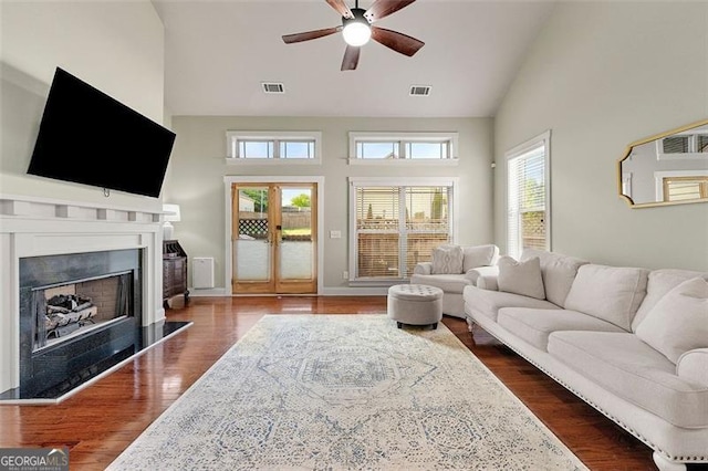 1399 Kilchis Falls Way, Braselton, GA 30517 - living area with high vaulted ceiling, ceiling fan, a fireplace with raised hearth, dark wood-style floors, and baseboards