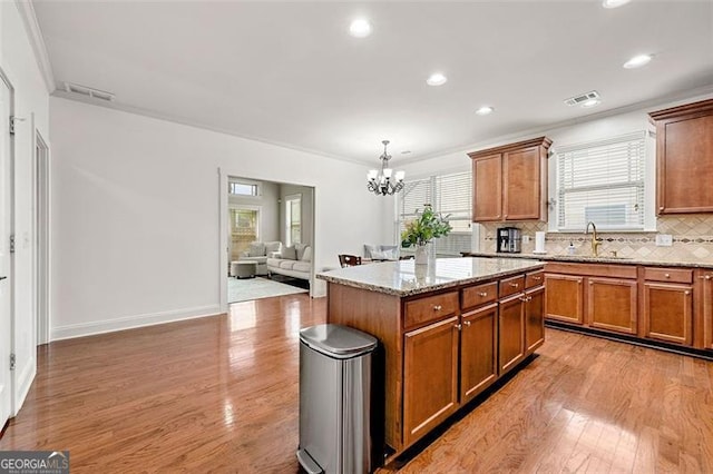 1399 Kilchis Falls Way, Braselton, GA 30517 - kitchen featuring a sink, light wood-style flooring, a chandelier, healthy amount of natural light, and recessed lighting