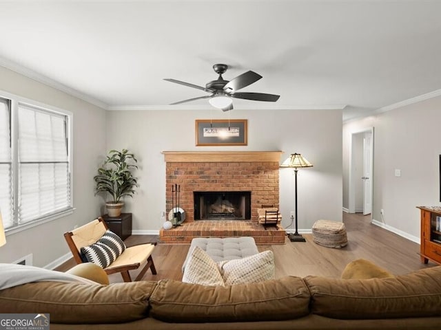 2458 Zachary Woods Dr, Marietta, GA 30064 - living area featuring crown molding, a ceiling fan, wood finished floors, baseboards, and a brick fireplace