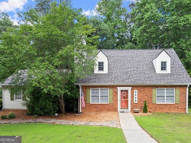 2458 Zachary Woods Dr, Marietta, GA 30064 - new england style home featuring brick siding, a front lawn, and roof with shingles