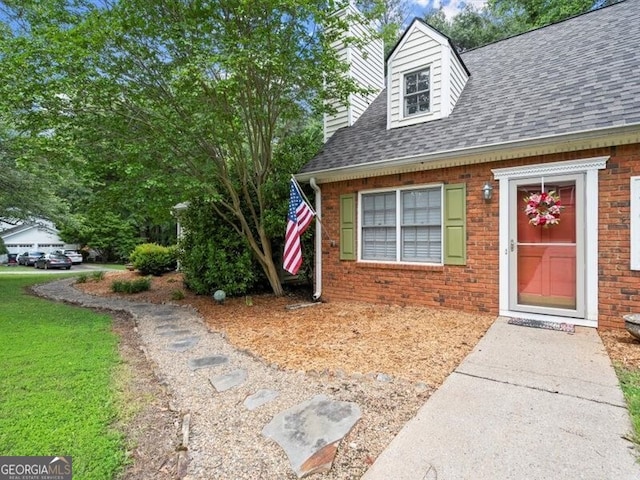 2458 Zachary Woods Dr, Marietta, GA 30064 - view of exterior entry featuring a shingled roof, brick siding, and a chimney