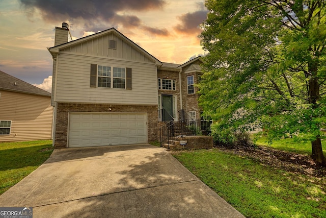 2000 Redwood Trce, Ellenwood, GA 30294 - view of front of property with an attached garage, board and batten siding, driveway, brick siding, and a chimney