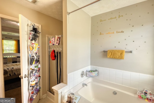 2000 Redwood Trce, Ellenwood, GA 30294 - bathroom featuring ensuite bath, a garden tub, and a textured ceiling