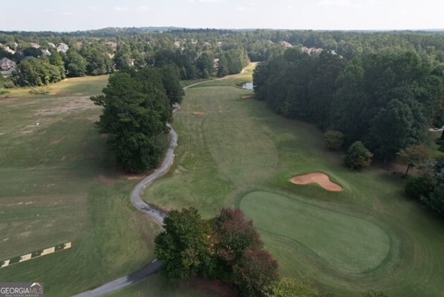 aerial view of property and surrounding area featuring a golf course