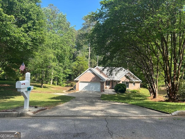 view of front of property with asphalt driveway, a front yard, and an attached garage