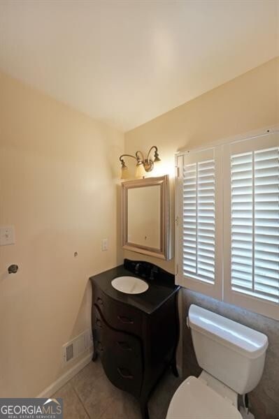 bathroom featuring tile patterned floors, toilet, and vanity