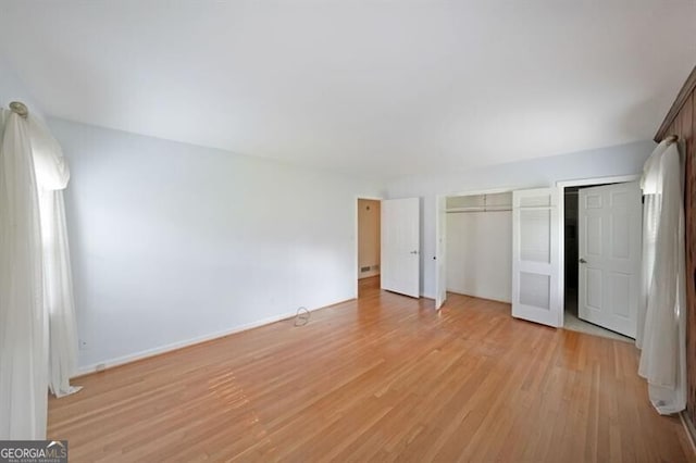 unfurnished bedroom with light wood-type flooring