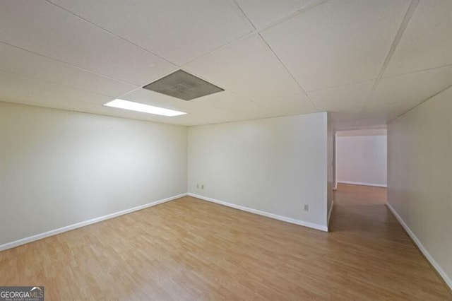 spare room with wood finished floors and baseboards