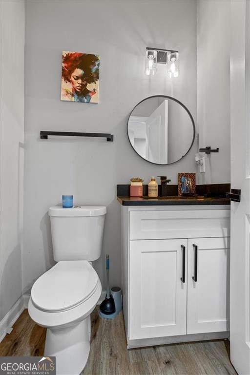 1174 Princess Ave SW, Atlanta, GA 30310 - bathroom featuring wood finished floors, vanity, toilet, and baseboards