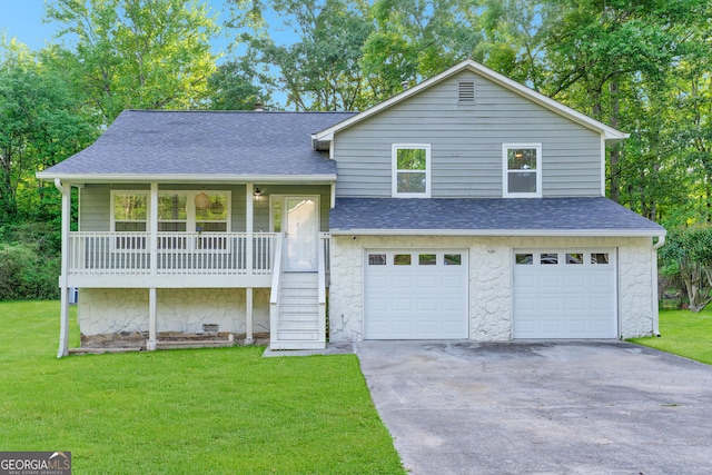 split level home with roof with shingles, a front yard, stone siding, and a garage