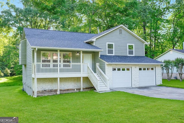 tri-level home with a porch, an attached garage, roof with shingles, concrete driveway, and a front yard