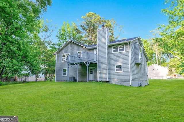back of house with a chimney and a wooden deck