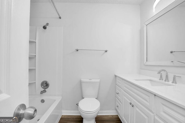 full bathroom featuring toilet, vanity, tub / shower combination, baseboards, and wood finished floors