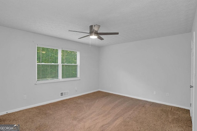 carpeted empty room with a ceiling fan, a textured ceiling, and baseboards