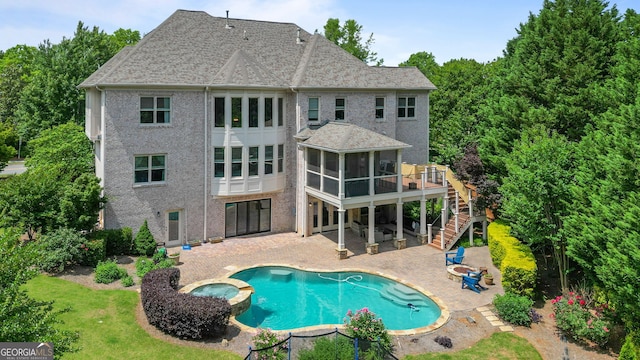 100 Braxton Way, Roswell, GA 30075 - rear view of property featuring a sunroom, stairway, a patio area, a pool with connected hot tub, and roof with shingles