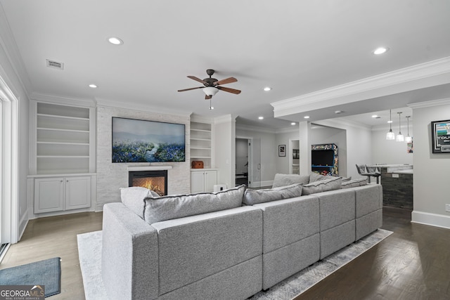 100 Braxton Way, Roswell, GA 30075 - living area with a large fireplace, baseboards, wood finished floors, recessed lighting, and built in shelves