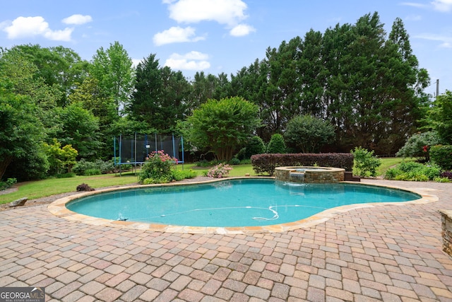 100 Braxton Way, Roswell, GA 30075 - view of swimming pool featuring a trampoline, a yard, a patio, and a pool with connected hot tub