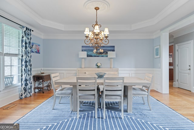 100 Braxton Way, Roswell, GA 30075 - dining room featuring a chandelier, light wood-type flooring, crown molding, a wainscoted wall, and a decorative wall