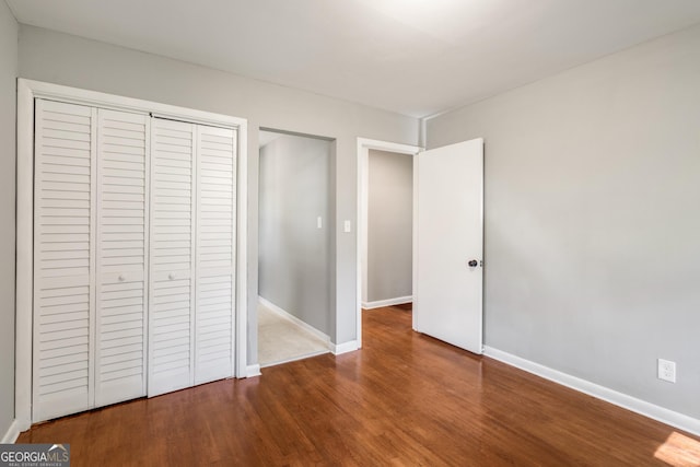 765 Shellnut Dr, Forest Park, GA 30297 - unfurnished bedroom featuring wood finished floors, a closet, and baseboards