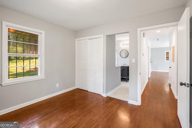 765 Shellnut Dr, Forest Park, GA 30297 - unfurnished bedroom with wood finished floors, baseboards, and a closet