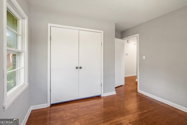 765 Shellnut Dr, Forest Park, GA 30297 - unfurnished bedroom with baseboards, wood finished floors, and a closet
