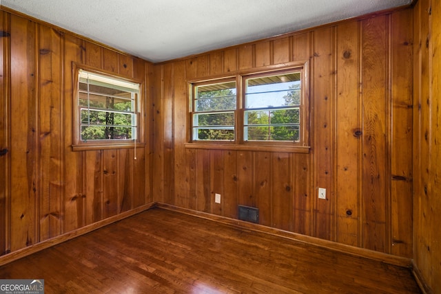765 Shellnut Dr, Forest Park, GA 30297 - spare room featuring wood finished floors, baseboards, and wood walls