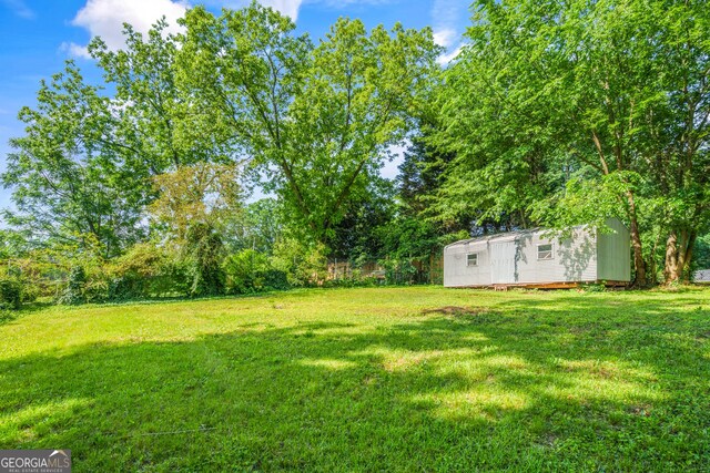 765 Shellnut Dr, Forest Park, GA 30297 - view of grassy yard featuring an outbuilding and a shed