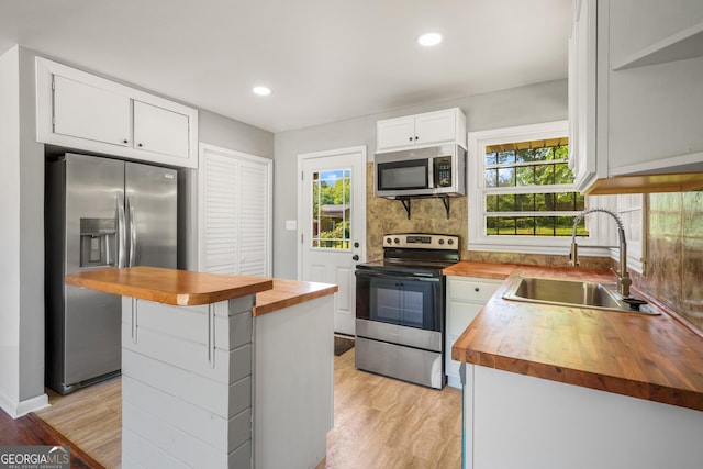 765 Shellnut Dr, Forest Park, GA 30297 - kitchen featuring wooden counters, stainless steel appliances, a sink, light wood-type flooring, and recessed lighting