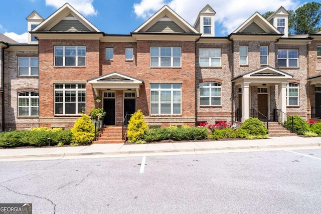 townhome / multi-family property featuring brick siding