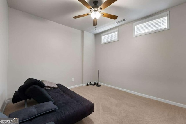 sitting room with carpet flooring, baseboards, and ceiling fan