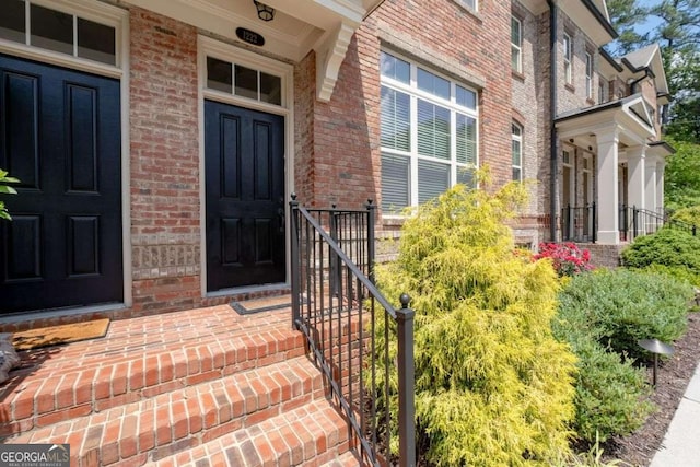 doorway to property with brick siding
