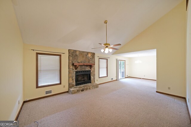 unfurnished living room featuring carpet floors, a ceiling fan, a stone fireplace, baseboards, and high vaulted ceiling