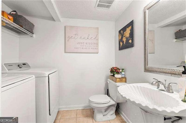 6900 Roswell Rd Unit 3N, Atlanta, GA 30328 - bathroom with independent washer and dryer, a textured ceiling, toilet, tile patterned floors, and baseboards