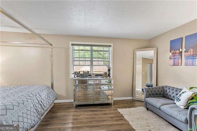 6900 Roswell Rd Unit 3N, Atlanta, GA 30328 - bedroom featuring wood finished floors, a textured ceiling, and baseboards