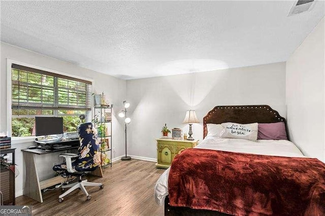 6900 Roswell Rd Unit 3N, Atlanta, GA 30328 - bedroom featuring wood finished floors, an office area, a textured ceiling, and baseboards