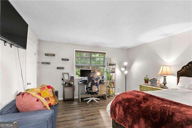 6900 Roswell Rd Unit 3N, Atlanta, GA 30328 - bedroom featuring wood finished floors, a textured ceiling, and a desk