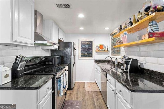 6900 Roswell Rd Unit 3N, Atlanta, GA 30328 - kitchen featuring range with electric stovetop, wall chimney exhaust hood, a sink, white cabinets, and light wood-style floors