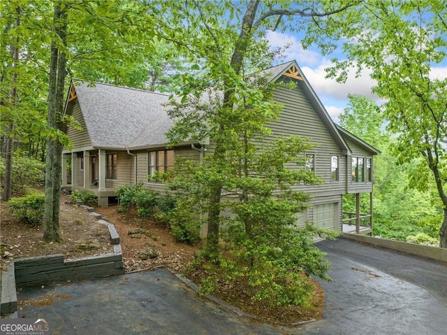 196 Mcelroy Mountain Dr, Jasper, GA 30143 - view of home's exterior featuring driveway, roof with shingles, a porch, and a garage