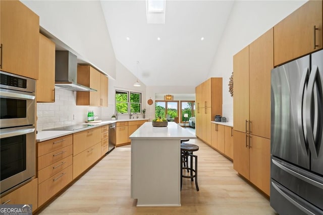 196 Mcelroy Mountain Dr, Jasper, GA 30143 - kitchen featuring appliances with stainless steel finishes, high vaulted ceiling, a kitchen breakfast bar, light wood-style flooring, and wall chimney exhaust hood