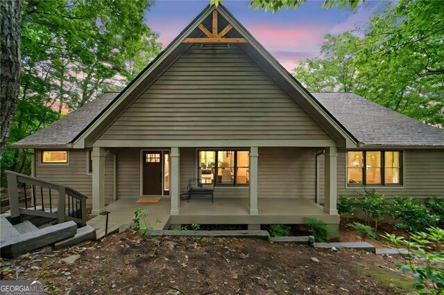 196 Mcelroy Mountain Dr, Jasper, GA 30143 - back of property at dusk with covered porch and roof with shingles