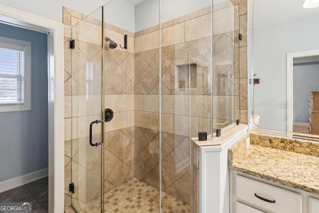 4 Honeysuckle Dr, Claxton, GA 30417 - bathroom featuring a stall shower, vanity, and baseboards