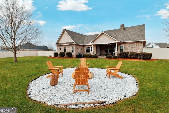 4 Honeysuckle Dr, Claxton, GA 30417 - rear view of house featuring an outdoor fire pit, a chimney, brick siding, roof with shingles, and a patio