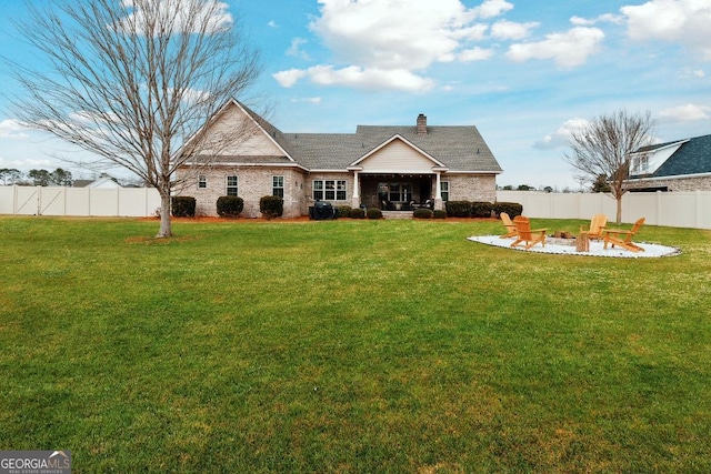 4 Honeysuckle Dr, Claxton, GA 30417 - rear view of property with an outdoor fire pit, a patio area, a chimney, and brick siding