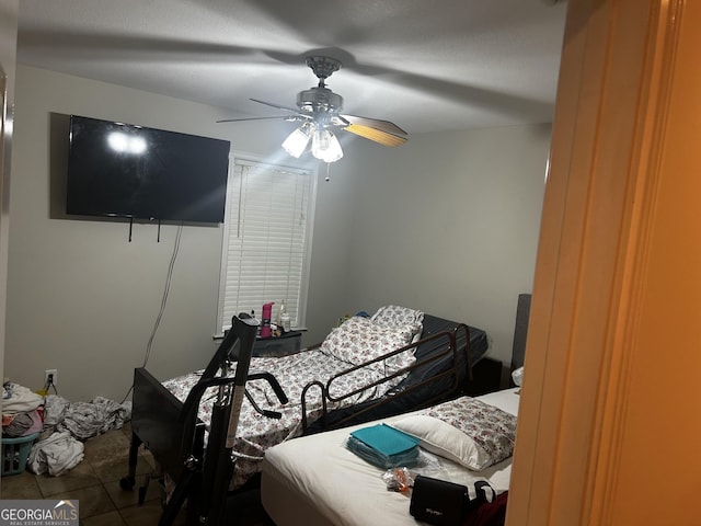 tiled bedroom with a ceiling fan
