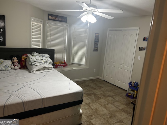bedroom with a closet, a ceiling fan, and baseboards