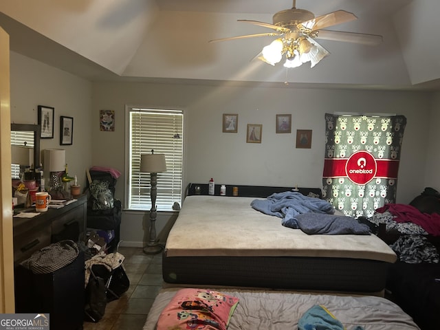 tiled bedroom with lofted ceiling and ceiling fan